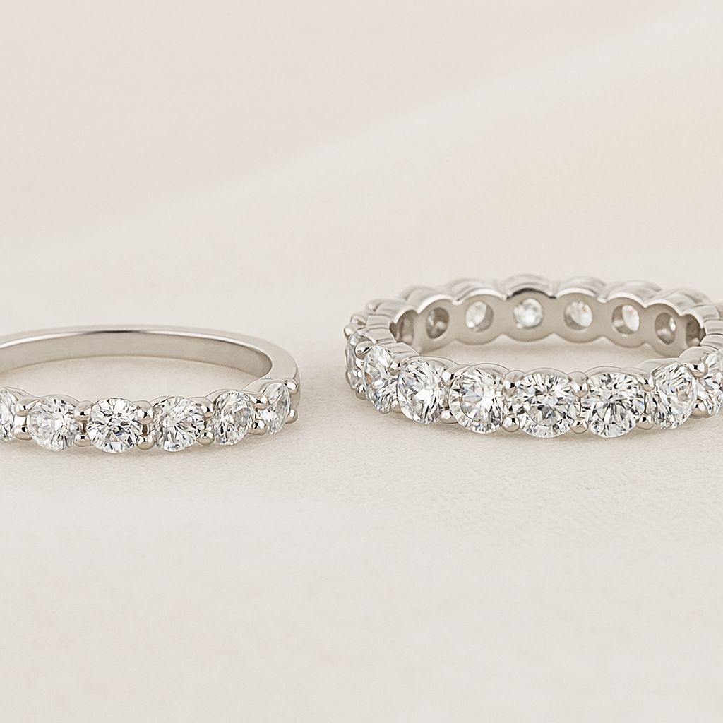 The Forever Ring (half eternity) beside The Everlasting Ring (full eternity) on a beige linen background—clear visual of half eternity vs full eternity bands for stacking.