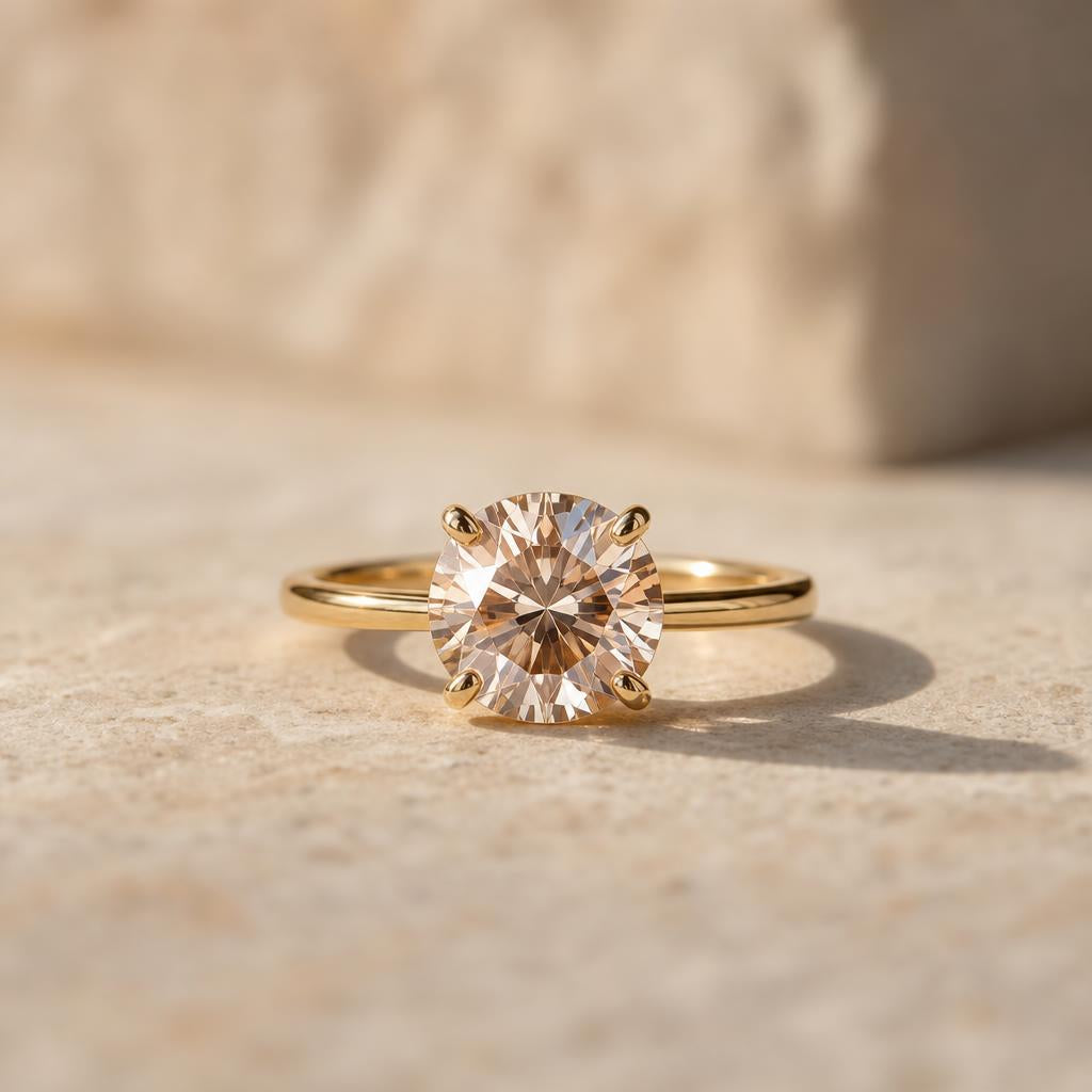 Close-up ring with faceted gemstone on warm cream stone surface