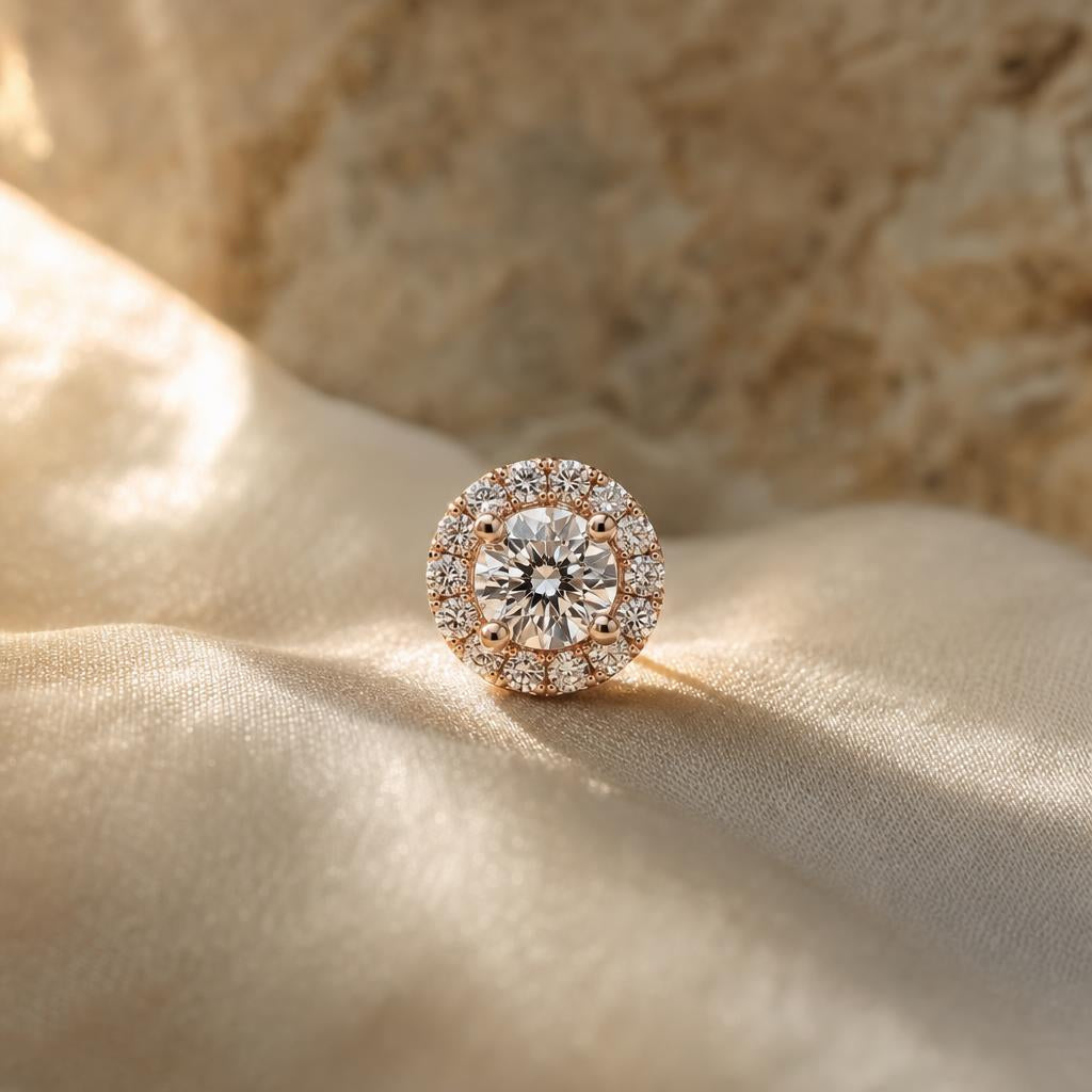 Close-up of a sparkling halo-set stud earring on cream silk
