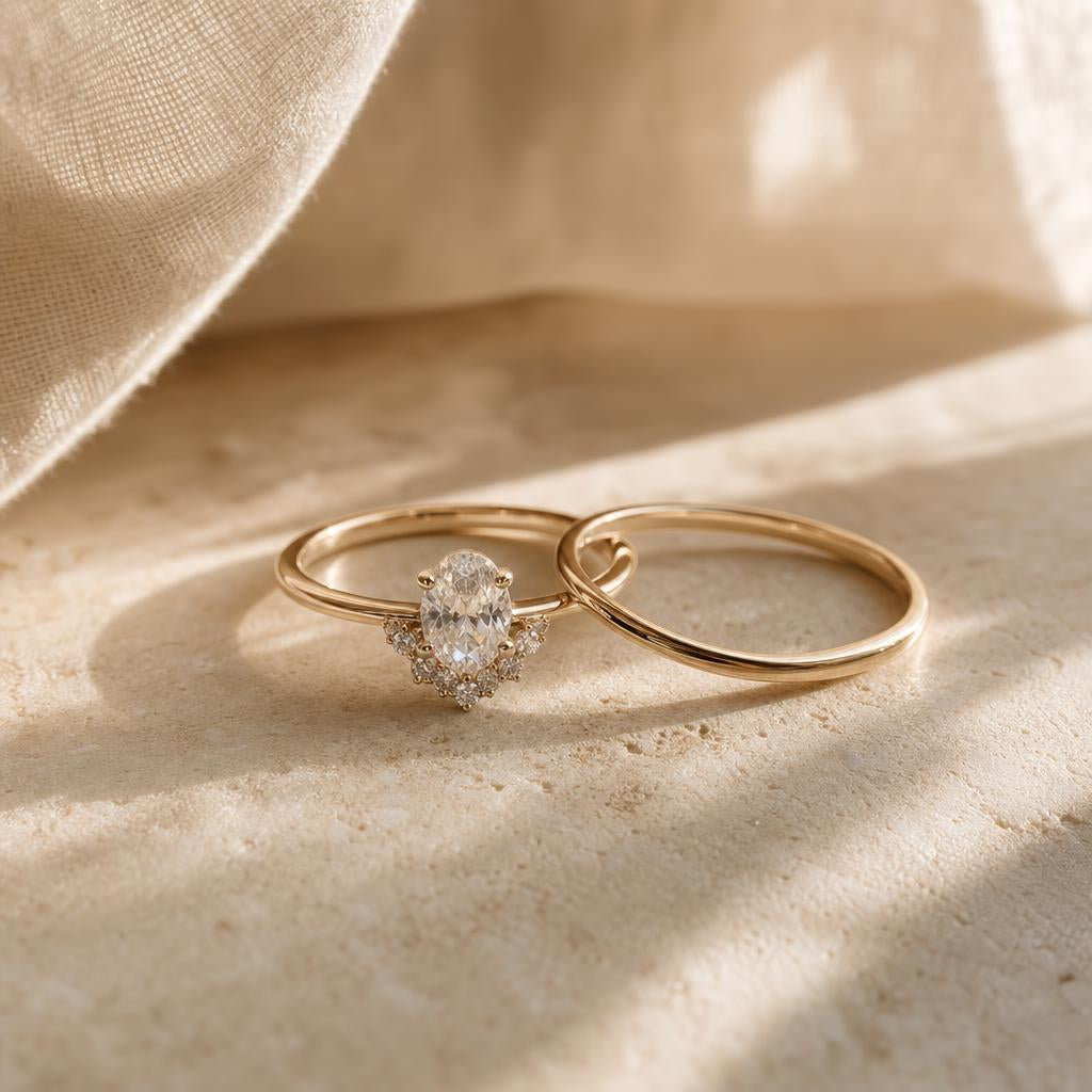 Two rings resting together on a warm stone surface