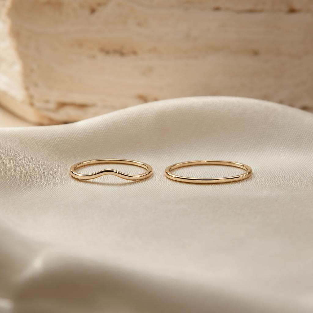 Two dainty stacking rings side by side, one curved, one straight