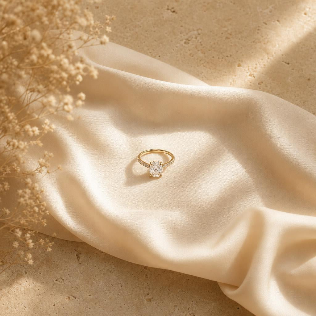 Single ring resting on warm cream silk with soft natural light