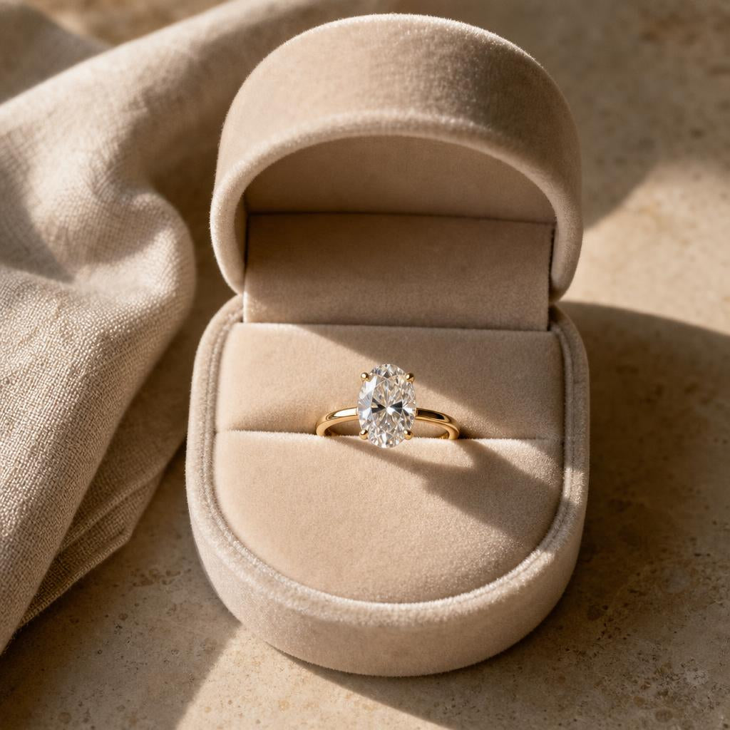 Single oval diamond engagement ring in an open velvet ring box