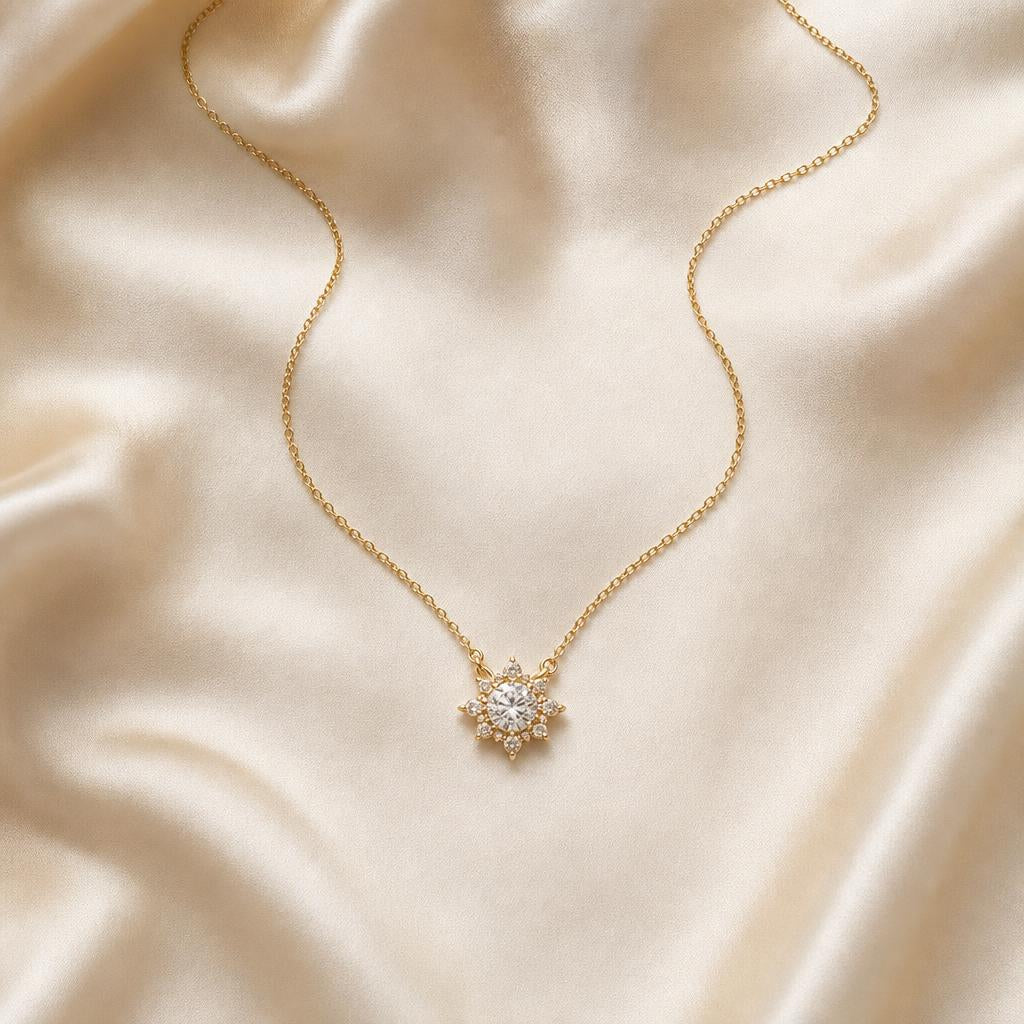 Delicate pendant necklace centered on soft cream silk fabric