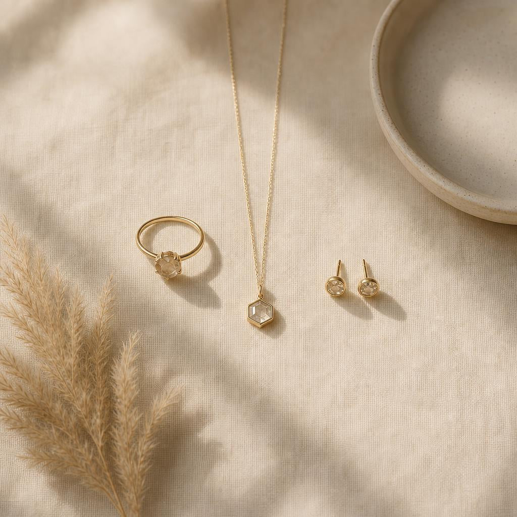 Small edited collection of rings, a necklace and earrings on cream linen