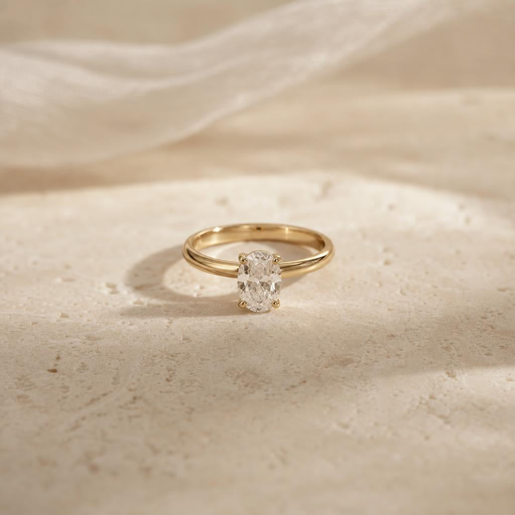 A single quiet luxury ring catching soft natural light on stone