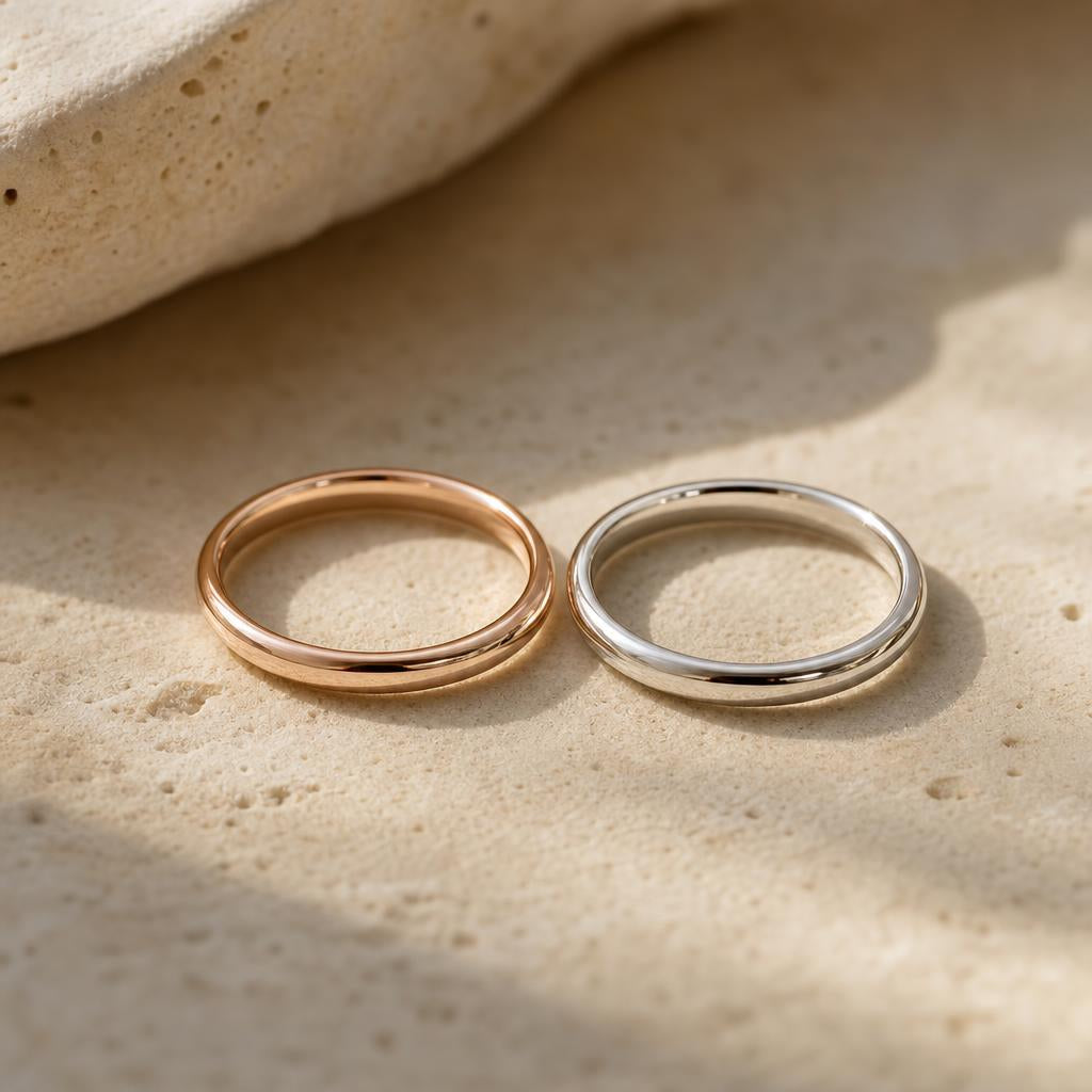 Rose gold and silver-toned wedding bands resting side by side