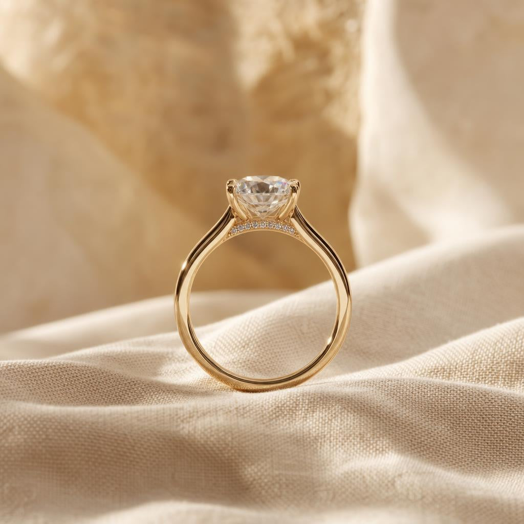Large faceted solitaire ring with hidden halo sparkle on warm cream fabric