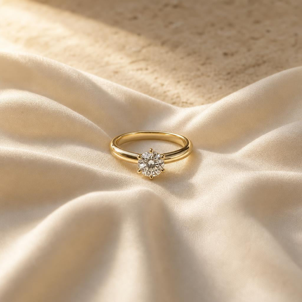 Single solitaire ring centered on warm cream silk fabric