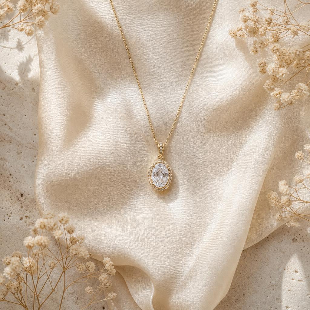 Elegant pendant necklace laid on cream silk with soft wedding styling