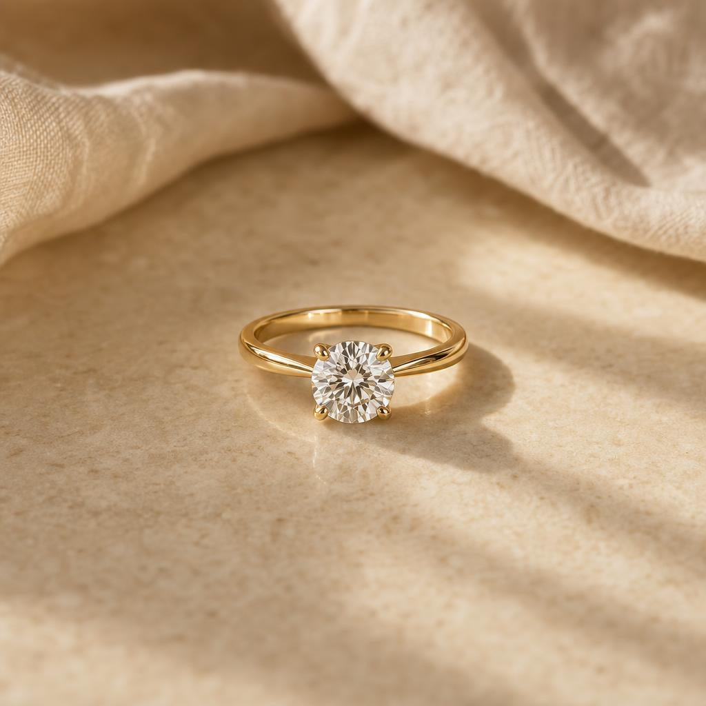 Single solitaire ring resting alone on a warm cream stone surface