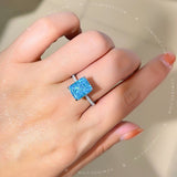 The Aura Ring Blue - Radiant Cut Solitaire with Side Halo